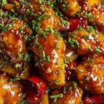 Sweet Chili Chicken glazed with sauce on white plate