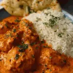 Butter Chicken served in copper bowl with naan