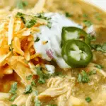Green Chile Chicken Enchilada Soup served in a rustic bowl