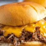 Slow Cooker Beef and Cheddar Sandwiches on rustic table