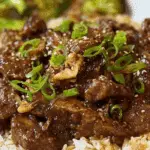 Slow Cooker Mongolian Beef served with rice and garnish