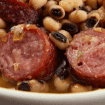 smoked sausage and black-eyed peas in a rustic bowl