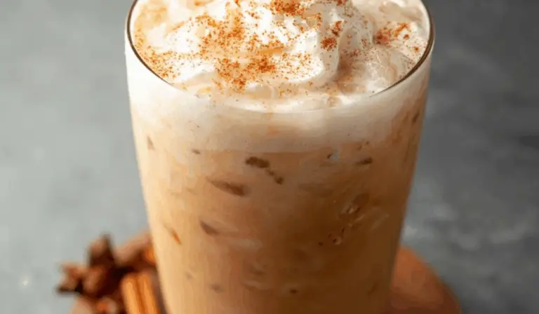 iced pumpkin cream chai tea latte in glass with pumpkin foam