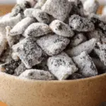 Cookies & Cream Puppy Chow in a bowl with powdered sugar
