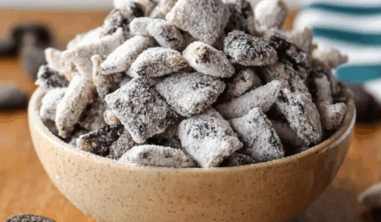 Cookies & Cream Puppy Chow in a bowl with powdered sugar