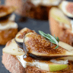 Brie, Apple, and Fig Crostini Appetizer on wooden board