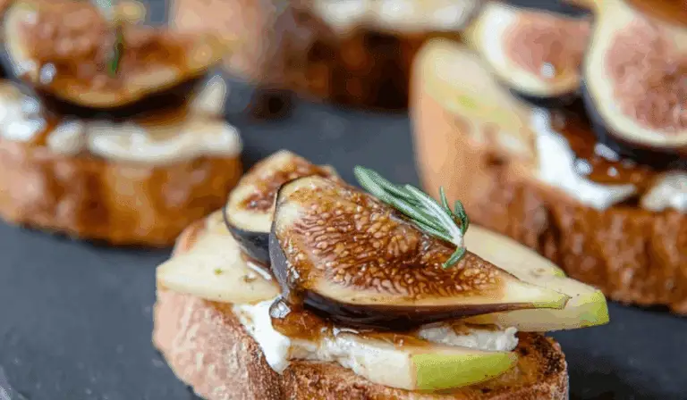 Brie, Apple, and Fig Crostini Appetizer on wooden board