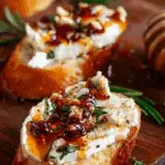 spicy honey drizzled feta crostini on wooden board