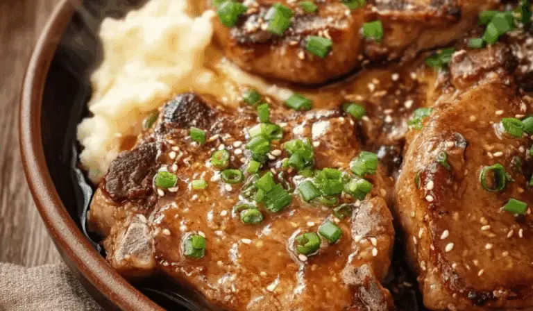 Tender slow cooker pork chops served with mashed potatoes