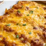Overnight Breakfast Enchiladas baked golden in a rustic dish