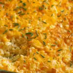 Cheesy Hashbrown Potato Casserole in a vintage baking dish