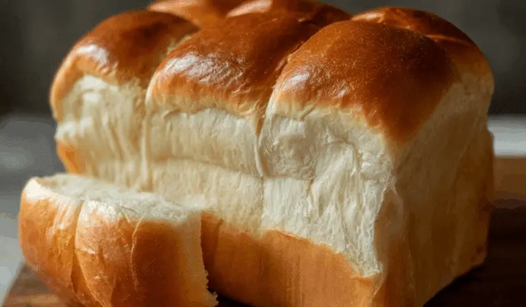 Homemade milk bread loaf on wooden board