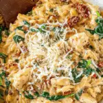 Slow Cooker Creamy Tuscan Chicken Orzo in rustic kitchen
