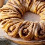 Cinnamon Roll Wreath fresh on wooden cake stand